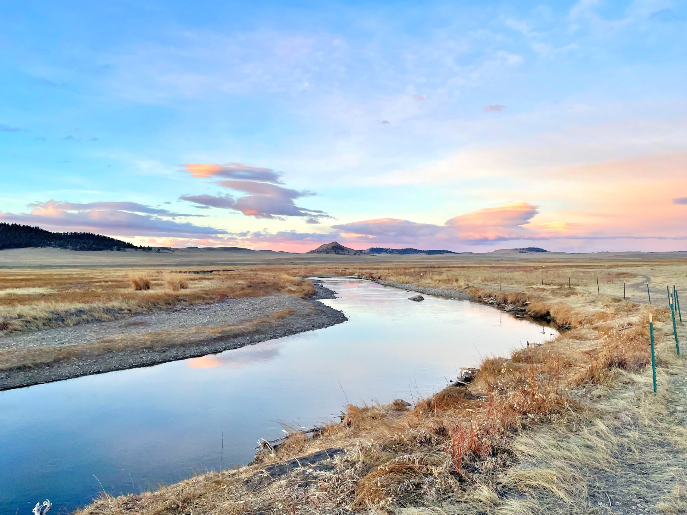 Meandering creek through high desert grassland at sunset — z is on the river